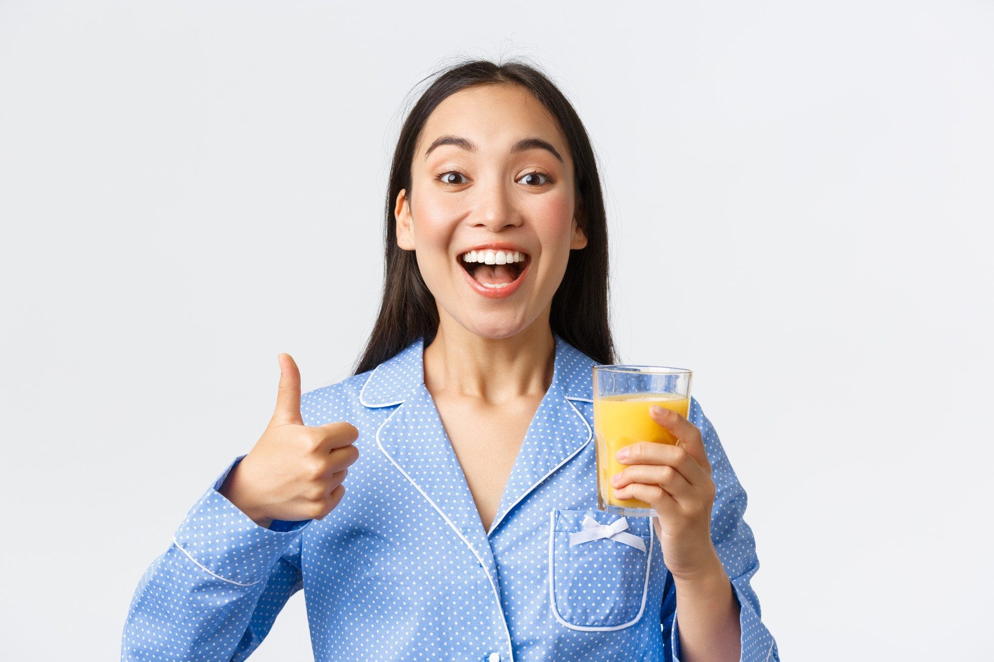 healthy-lifestyle-morning-routine-people-concept-close-up-excited-beautiful-asian-girl-pajama-having-habit-drinking-fresh-orange-juice-full-vitamins-showing-thumbs